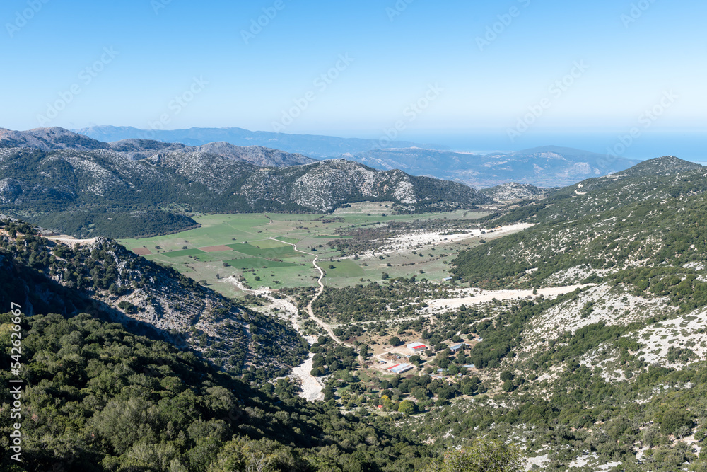 A mountain top view of the landscape below with a panoramic view to infinity.