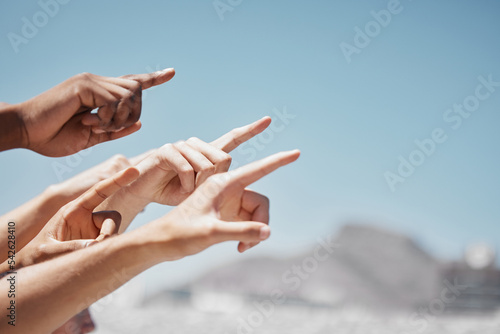 Fotografija Group hands, fingers and pointing to sky mockup, direction and advertising space of global community outdoors