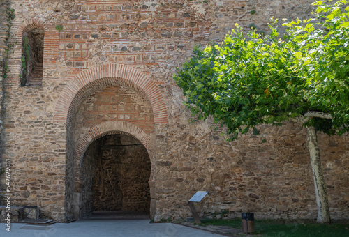 Antigua puerta en arco de estilo mudéjar en las murallas medievales de la villa de Buitrago de Lozoya, España photo