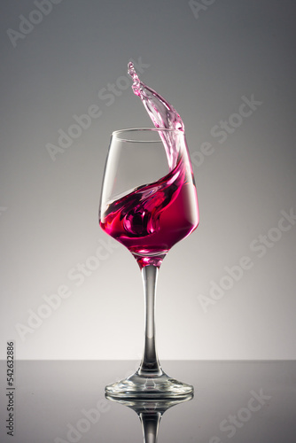 Glass of wine on grey background.