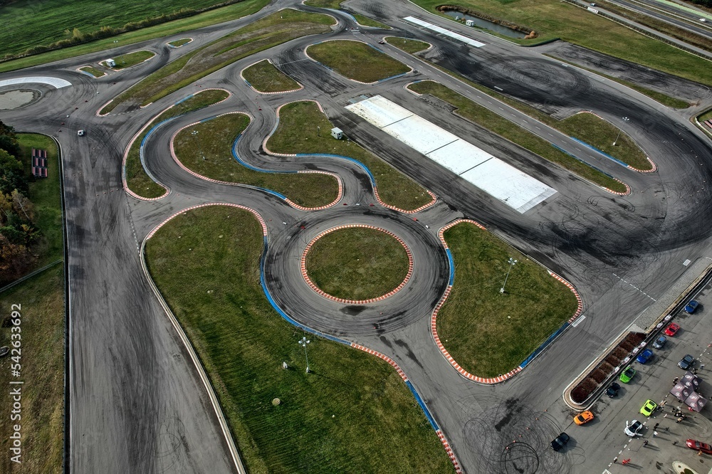 car racing track and racing cars as seen from above from a drone. Fast, luxury cars.