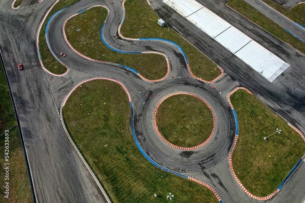 car racing track and racing cars as seen from above from a drone. Fast, luxury cars.