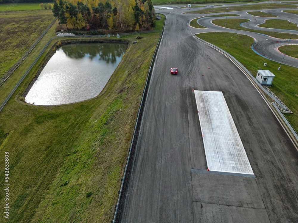 car racing track and racing cars as seen from above from a drone. Fast, luxury cars.