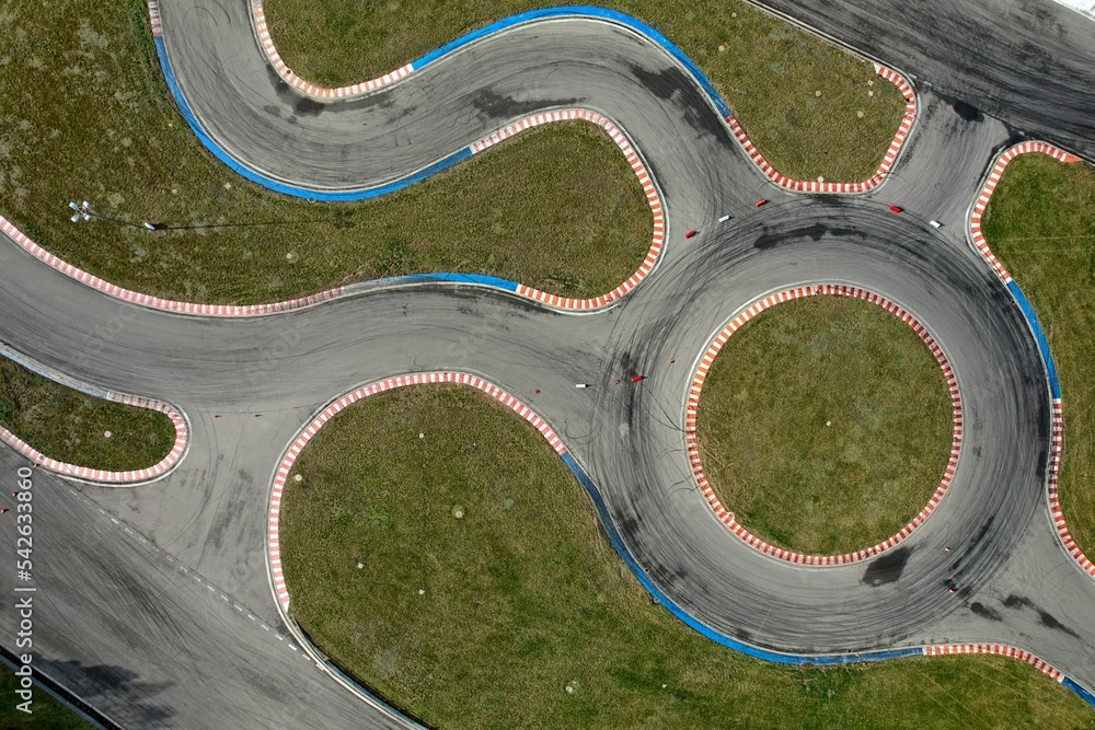 car racing track and racing cars as seen from above from a drone. Fast, luxury cars.