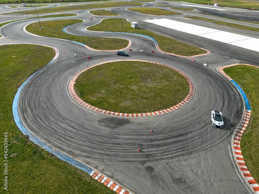 car racing track and racing cars as seen from above from a drone. Fast, luxury cars.