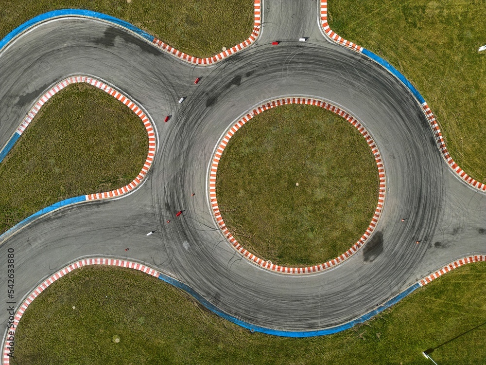 car racing track and racing cars as seen from above from a drone. Fast, luxury cars.