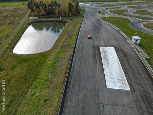 car racing track and racing cars as seen from above from a drone. Fast, luxury cars.