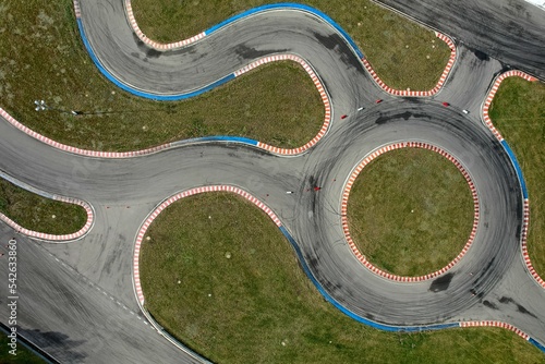 Obraz na płótnie car racing track and racing cars as seen from above from a drone. Fast, luxury cars. w salonie