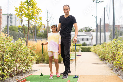 Family: Family Time Playing Mini-Golf In The Summer. photo