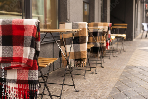comfy seats in a street cafe with blankets