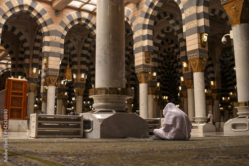 Muslims praying inside Nabawi Mosque. Interior view of Masjidil Nabawi (Nabawi Mosque) in Medina. photo