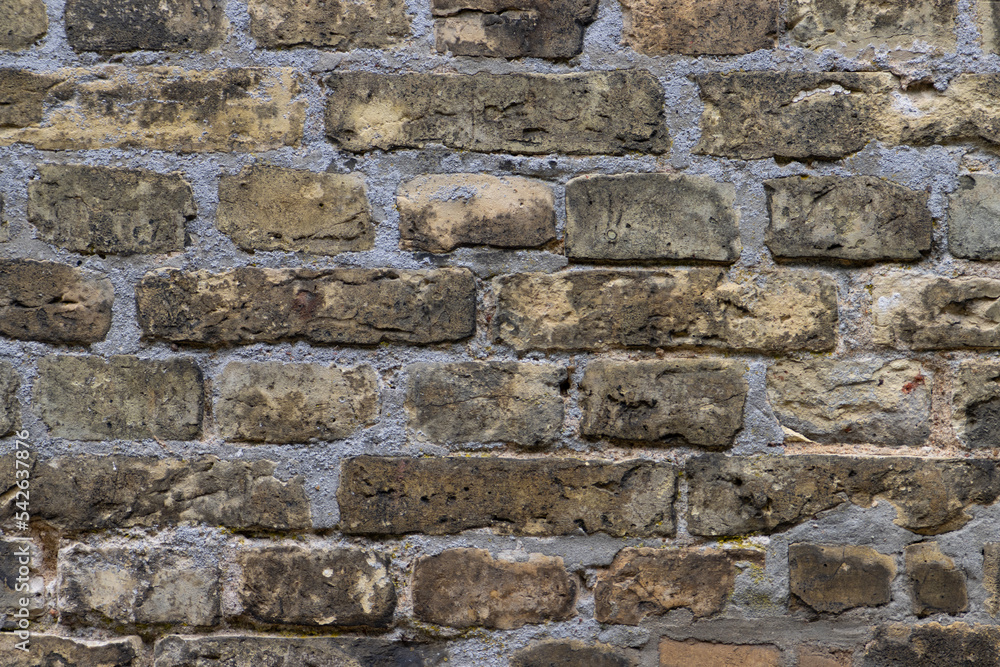 Old weathered beige brown brick wall background Old weathered beige brown brick wall background