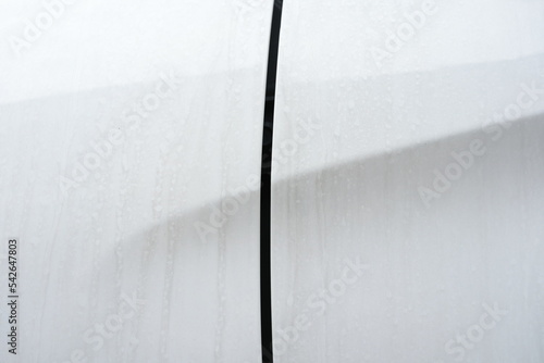 Water Stains and Dust on White Surface of Car Body, Suitable for Car Care Concept.