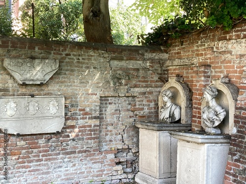 Old statues in the hidden gardens of Ca rezzonico in Venice, Italy