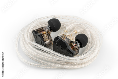 In ear monitor on a tablature background. Custom in-ear monitors with black plates. Custom in ear monitors or IEMs ready for a musician to wear on stage at a concert. photo