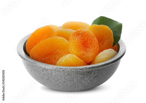 Ceramic bowl with tasty dried apricots and leaf isolated on white