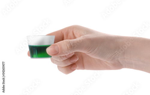 Woman holding measuring cup with syrup isolated on white, closeup. Cough and cold medicine