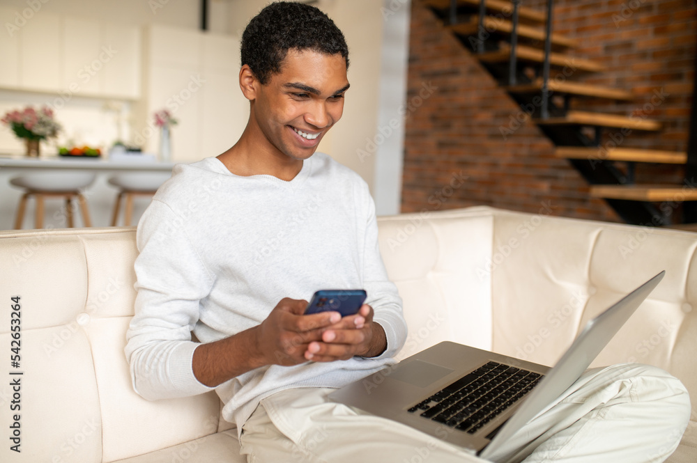 Young handsome dark-skinned man with a laptop Young handsome dark-skinned man with a laptop