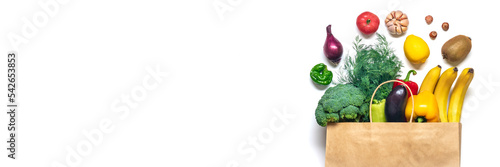 Eco friendly paper shop bag with raw organic green vegetables isolated on white background Flat lay, top view Zero waste, plastic free concept Healthy clean eating diet and detox, agriculture concept
