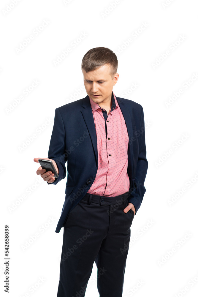 businessman, businessman holds a phone in his hand and looks into it. young man in a business suit takes an important call. isolated businessman, businessman holds a phone in his hand and looks into it. young man in a business suit takes an important call. isolated
