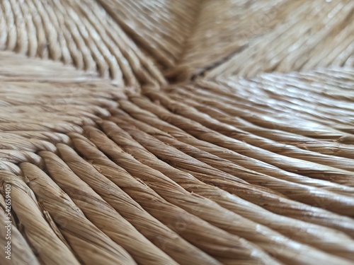 Textured woven straw background in a chair seat photo