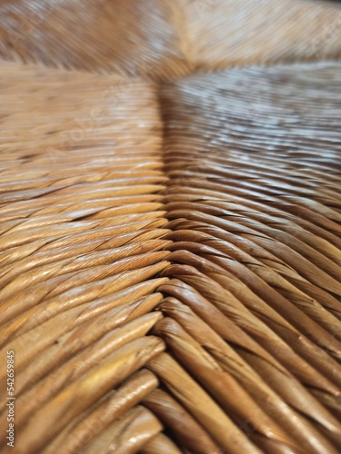 Textured woven straw background in a chair seat photo