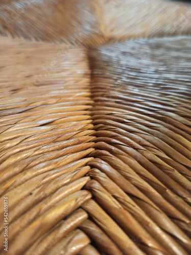 Textured woven straw background in a chair seat photo