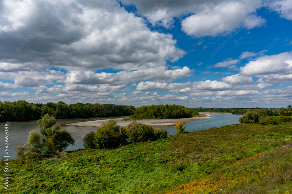 landscape of the Katun River floodplain on a sunny day with light clouds in the sky. Altay, Russia
