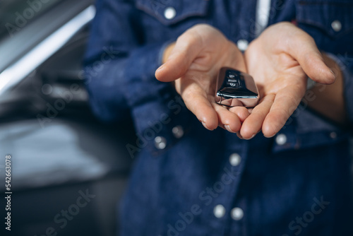 Woman holding car keys from a new car