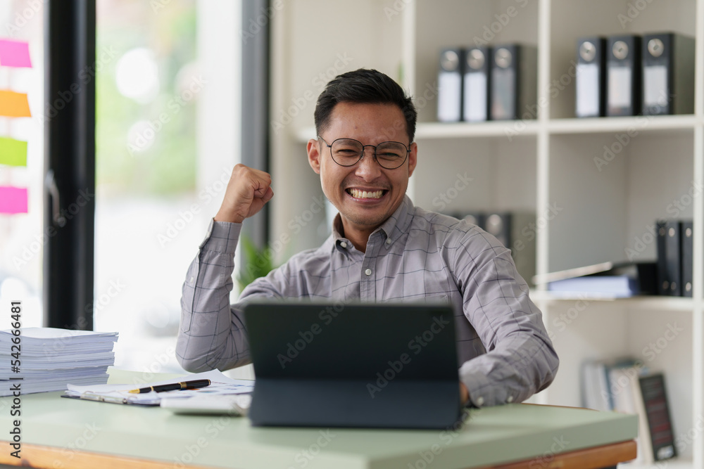 Pleasant positive businessman using digital tablet at home office