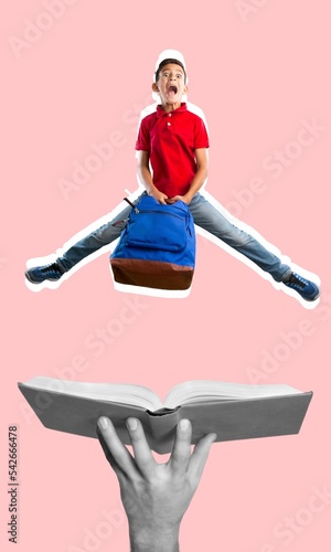 Young student jumping on hand with open book