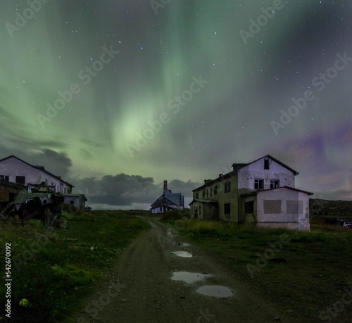 Northern Lights in the abandoned village of Dalniye Zelentsy. Rocks are two brothers. The Kola Peninsula. Russia photo