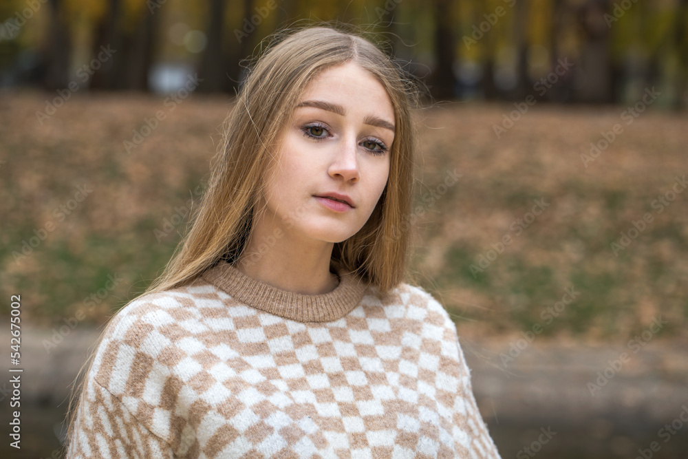 Portrait of a young beautiful blonde girl in an autumn park Portrait of a young beautiful blonde girl in an autumn park