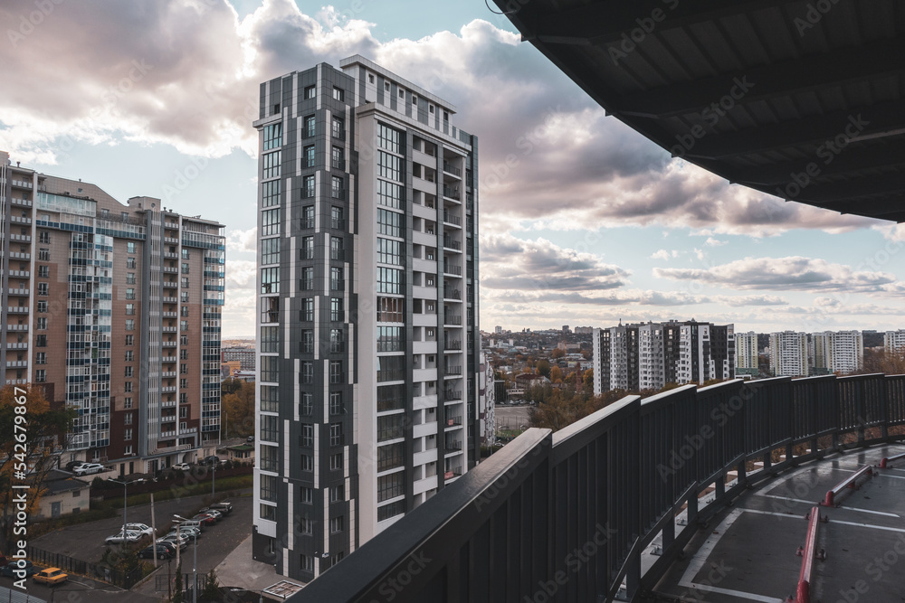 Obraz premium Modern residential buildings from multilevel parking, downtown streets architecture in evening in autumn Kharkiv, Ukraine