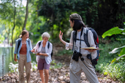 Backpack tourist travel outdoor adventure bird study using binoculars looking and record to book photo