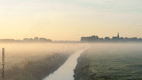Sunrise with fog over the fields of 'T Woudt, The Netherlands. photo