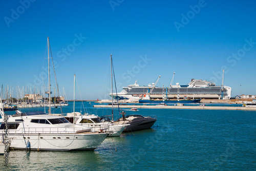 Marina bay with yachts, vessels, sailboats and other ships in Livorno, Italy. Sunny day with blue sky and sea water  © SWRSC