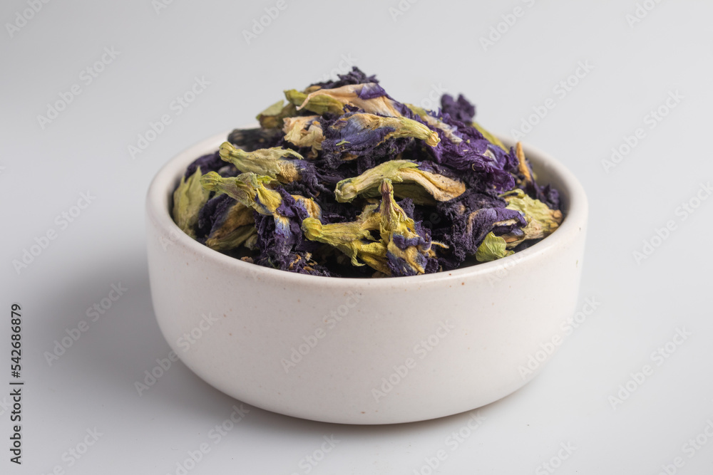 dried pea flowers in a white cup on a white background dried pea flowers in a white cup on a white background
