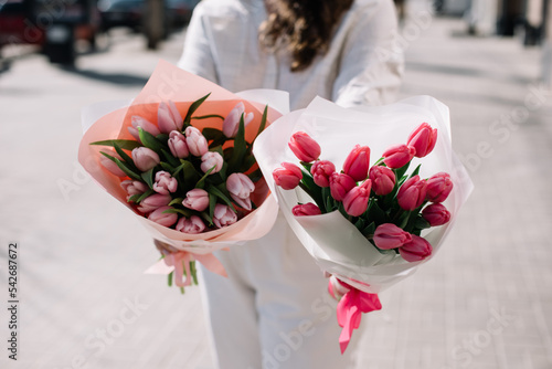 Wallpaper Mural Very nice young woman holding two beautiful, different sized bouquets of fresh pink tulip flowers, cropped photo, bouquet close up Torontodigital.ca