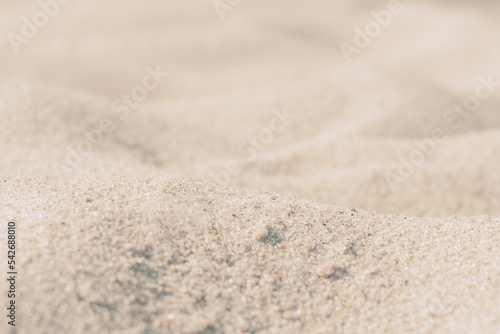 Close-up of sand on the beach. Toned photo with low depth of field. Small grains of sand on a clean beach.
