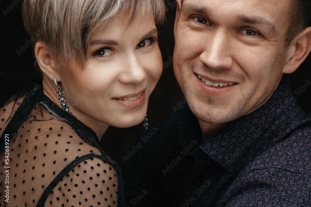 Close-up of the face of a man and a woman. Beautiful young couple smiles as they look at the camera. The concept of a happy family Close-up of the face of a man and a woman. Beautiful young couple smiles as they look at the camera. The concept of a happy family