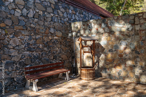 Bench and well near the stone wall