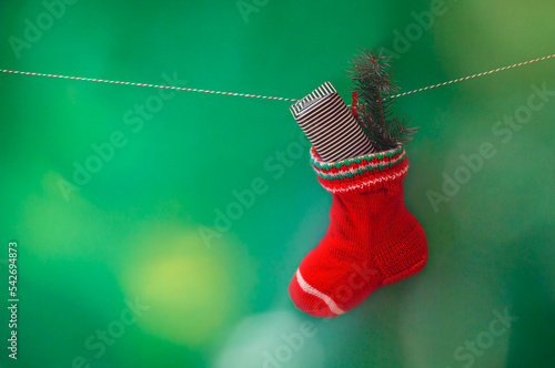 Christmas stocking hanging on green background photo