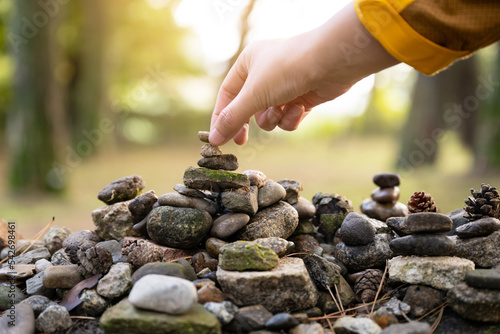 Obraz na plátně  building a stone tower with one's hands at temple