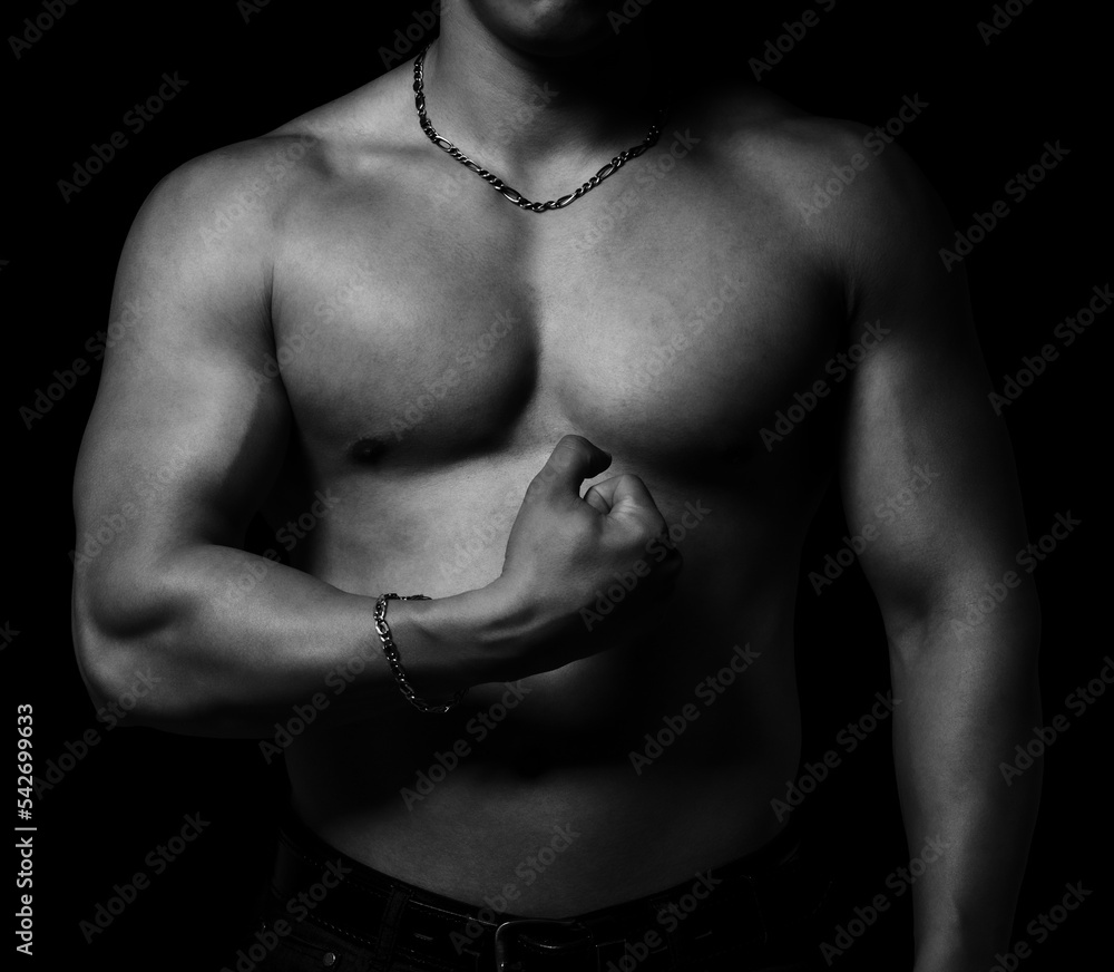 Bodybuilder showing his muscular body isolated on black background Bodybuilder showing his muscular body isolated on black background