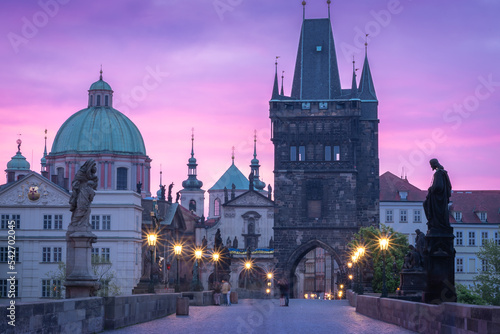 Colorful sunrise at historical city centre, Charles bridge lined with street lamps, Prague, Czechia