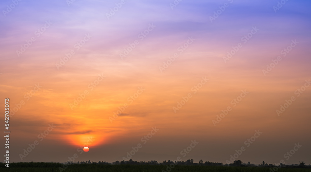 Sunset sky in the evening with colorful orange sunlight clouds on twilight, Dusk sky background 