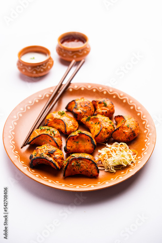 Tandoori momo, veg or non veg in red and cream sauce, served with sauce.  Nepal and Tibet recipe photo