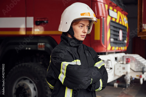 Woman firefighter in uniform is at work in department photo