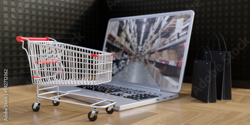 Eshop, online order and delivery. Supermarket cart, shopping bags and laptop photo